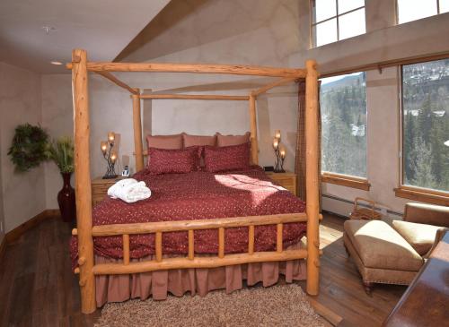 a bedroom with a wooden bed with a wooden frame at Elkhorn 509 in Avon