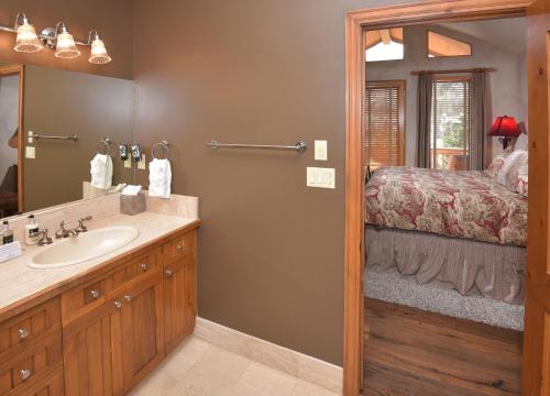 a bathroom with a sink and a bed at Elkhorn 509 in Avon