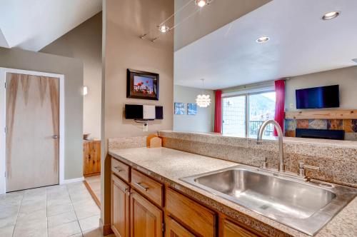 a large kitchen with a sink and a window at Plaza 1407 in Keystone
