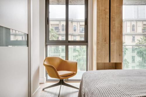 a bedroom with a chair in front of a window at Downtown 1BR w Pool Gym WD nr Staples Center LAX-547 in Los Angeles