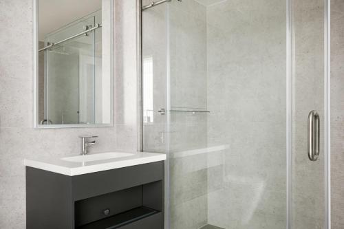 a bathroom with a sink and a glass shower at Downtown 1BR w Pool Gym WD nr Staples Center LAX-547 in Los Angeles
