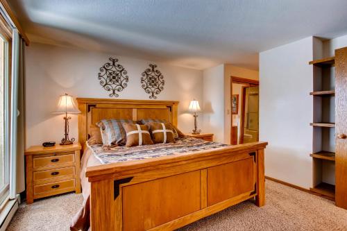 a bedroom with a large wooden bed with pillows at View Of Mt, Crested Butte And Lifts 2 Br Condo Condo in Crested Butte