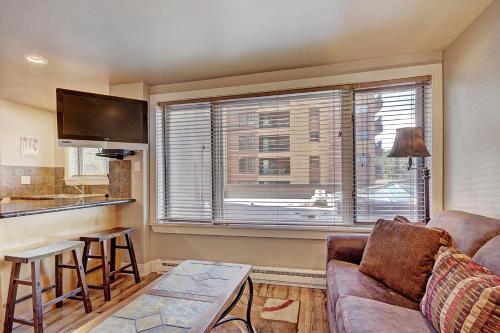a living room with a couch and a large window at Village at Breck V4309 in Breckenridge