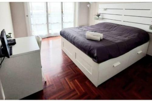 a bedroom with a bed and a desk and a computer at Franco SanSiroHouse Rho MI Fiera in Milan