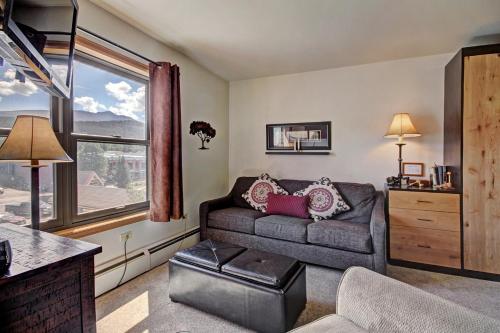 a living room with a couch and a large window at Studio Apartment with Balcony in Breckenridge