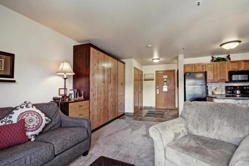 a living room with a couch and a kitchen at Studio Apartment with Balcony in Breckenridge
