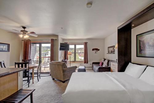 a bedroom with a large bed and a living room at River Mtn Lodge E205 in Breckenridge