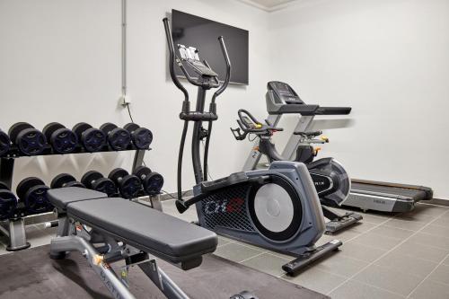 a gym with a treadmill and a exercise bike at Sunshine Apartment Spirit of Deer in Garmisch-Partenkirchen