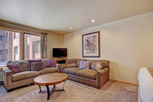 a living room with two couches and a table at Village at Breck V4224 in Breckenridge