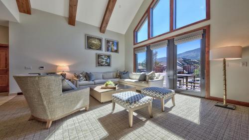 a living room with a couch and chairs and windows at Zalanta 317 in South Lake Tahoe