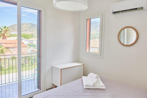 a bedroom with a bed and a large window at Salinelle Rooms in Lascari
