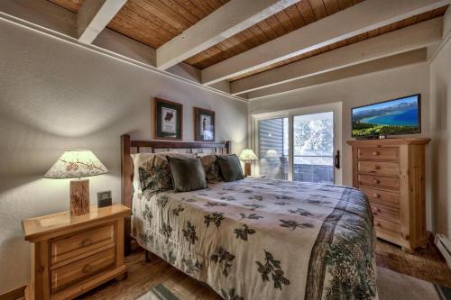 a bedroom with a bed and a dresser and a window at Newly Remodeled 1 Bed and Loft at Lakeland Village in South Lake Tahoe