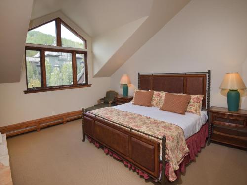 a bedroom with a large bed and a window at The Pines 401 in Beaver Creek