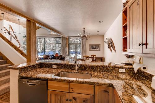 a kitchen with a sink and a counter at Ski Tip Townhomes 8713 in Keystone