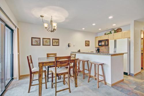 a kitchen and dining room with a table and chairs at Two-Bedroom Apartment in Breckenridge