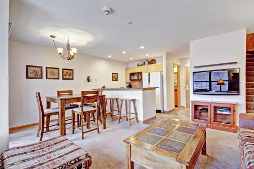 a kitchen and living room with a table and chairs at Two-Bedroom Apartment in Breckenridge