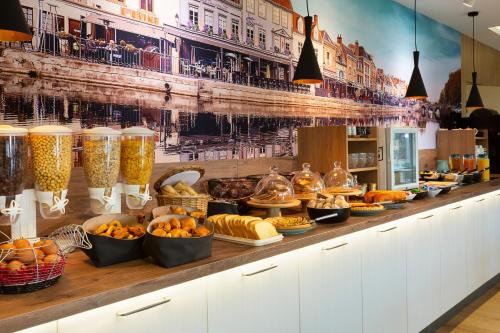 a buffet line with many different types of food at Brit Hotel Confort Amiens in Longueau