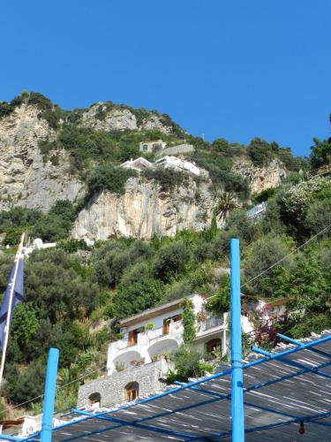 a building on a hill with a mountain at La Dolce Vita a Positano boutique hotel in Positano