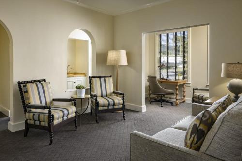 a living room with chairs and a couch and a table at Fairmont Sonoma Mission Inn & Spa in Sonoma