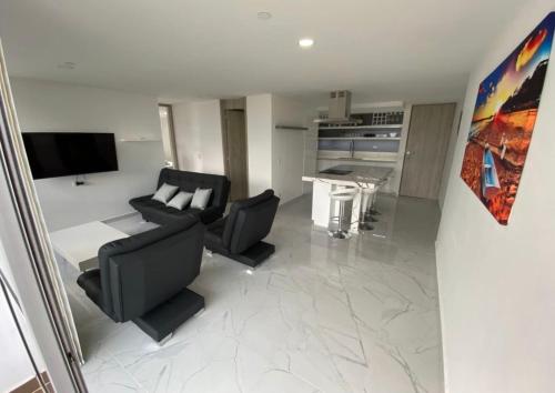 a living room with a couch and a table at Lujoso apartamento en envigado,con hermosa y exclusiva vista in Envigado
