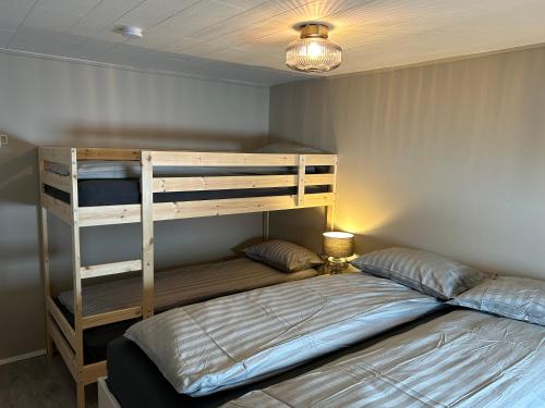 a bedroom with a bunk bed and a lamp at The Painter's house in Siglufjörður