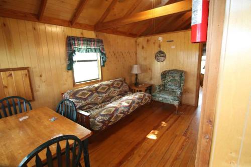 a living room with a couch and a table at Lakefront Cedar Cabin - 9 in Mead