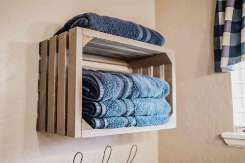 a wooden towel rack with blue towels in a bathroom at Lake Access Quad-plex Kitchenette - 29 in Mead