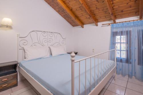 a bedroom with a bed and a balcony at Villa Emily in Syvota