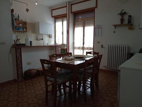 a kitchen with a table and chairs in a room at CasAda spazioso e luminoso appartamento in Tricase