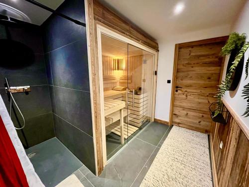 a bathroom with a walk in shower next to a walk in closet at Chalet Les Gets, 5 pièces, 14 personnes - FR-1-598-41 in Les Gets