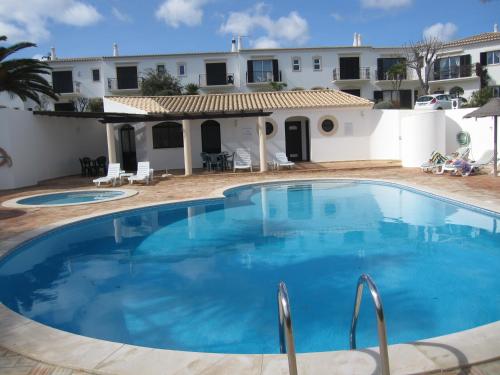 a large swimming pool in front of a house at Villa Figueira in Figueira