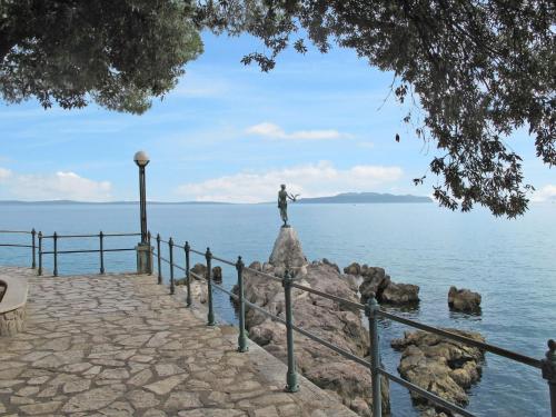 a statue of a man standing on a rock in the water at Apartment Deni-1 by Interhome in Volosko
