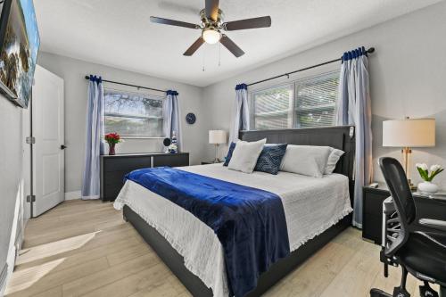 a bedroom with a bed and a ceiling fan at A Wave From It All in Largo