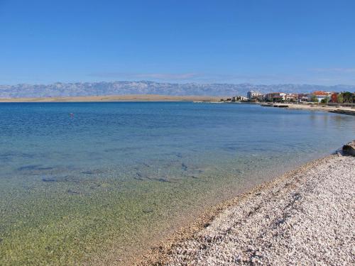 a large body of water with a rocky beach at Apartment Lidija by Interhome in Vir