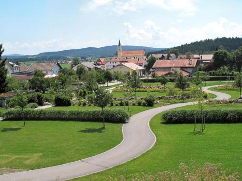 a winding road in a park with a town in the background at Holiday Home Triendl by Interhome in Bischofsmais
