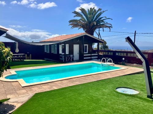 a swimming pool in the yard of a house at Casa Inmaculada in Maspalomas