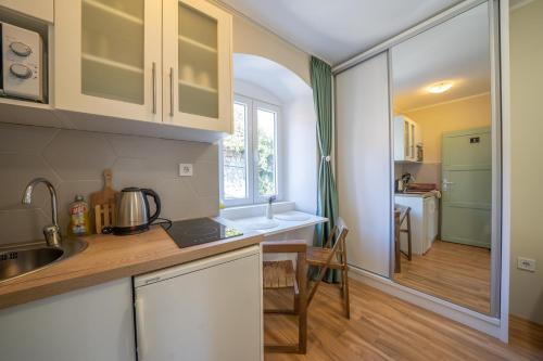 a kitchen with a sink and a counter top at Apartmani Zukic in Risan