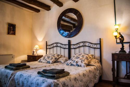 a bedroom with a bed with towels on it at La Fuente del Monte in Caballar