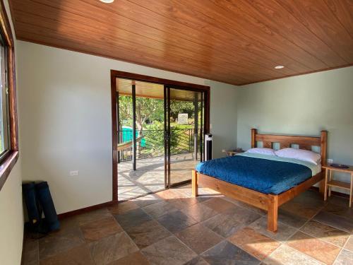 a bedroom with a bed and a sliding glass door at Indigo Container House in San Luis