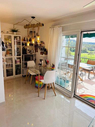 a dining room with a table and chairs and a window at FLAT Surrounded by Nature WIFI & Pool & beach Nearby in Son Parc