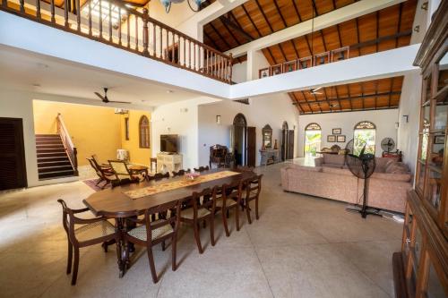 a large living room with a wooden table and chairs at GALLE HERITAGE VILLA in Galle