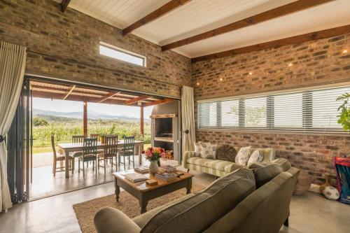 a living room with a brick wall at Libertas Guest Farm in Hoekwil