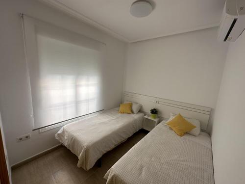 Llit o llits en una habitació de Adosado Mar Serena