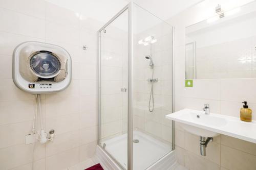 a bathroom with a shower and a sink at Self check-in apartments by Amber in Bratislava