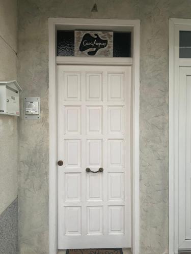 Una puerta blanca con un cartel encima. en Casa Arques, en Deltebre