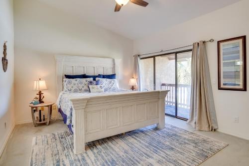 een slaapkamer met een bed en een groot raam bij Sun-Dappled PCB Retreat with Multiple Pools! in Panama City Beach