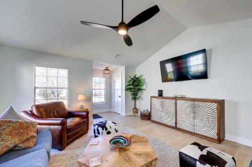 a living room with a couch and a ceiling fan at Chic Bentonville Home with Patio and Fire Pit! in Bentonville