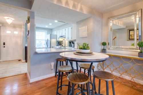 a kitchen with a table and four stools at Quaint Arlington Vacation Rental with Patio! in Arlington