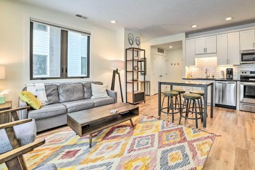 a living room with a couch and a table at Traverse City Condo Half Mi to Front Street! in Traverse City