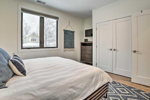 a bedroom with a large bed and a window at Traverse City Condo - Half-Mile to Front Street in Traverse City